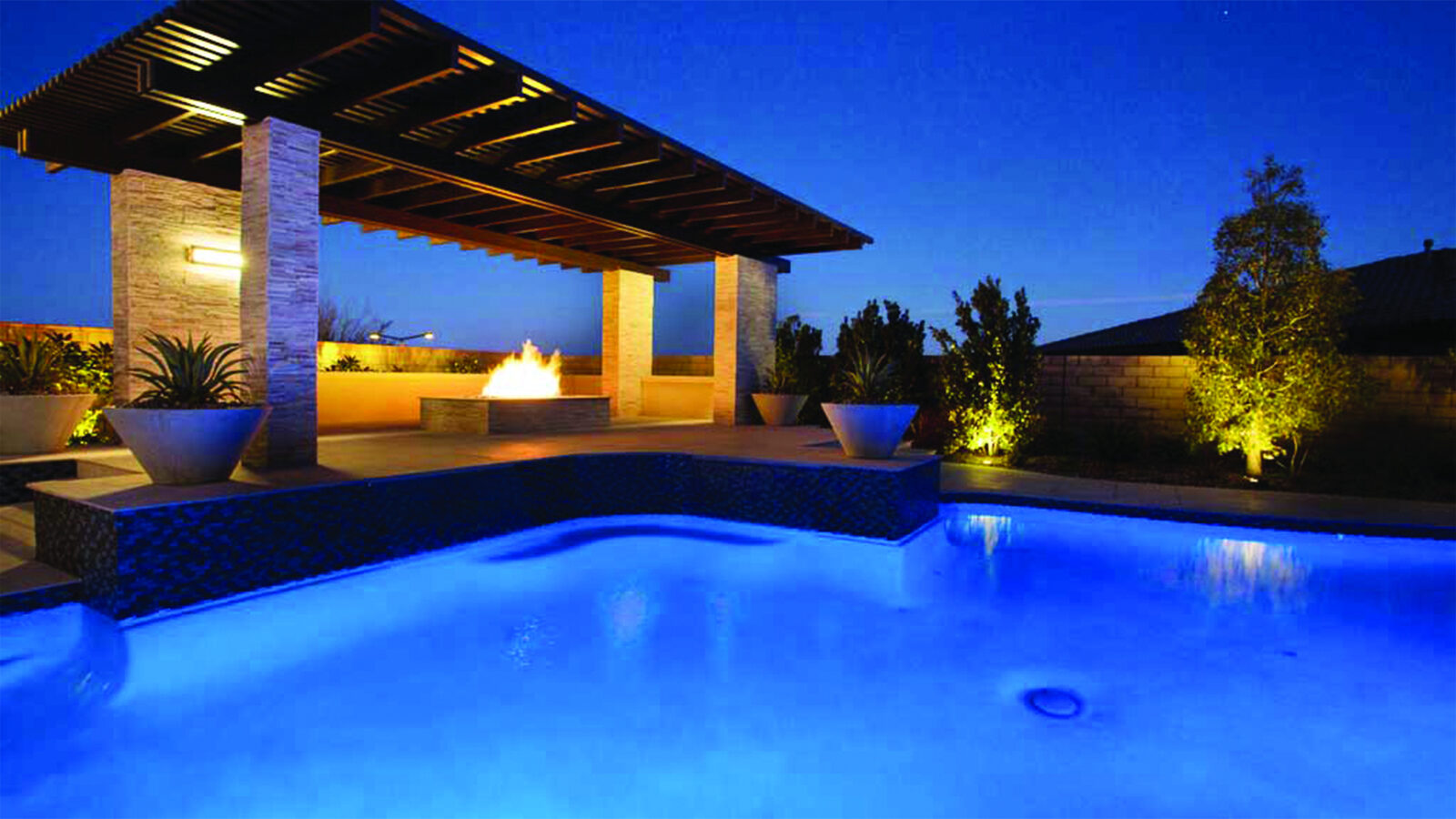 Ramada, linear fire, water at blue hour — EverClear Pools, the Las Vegas Valley